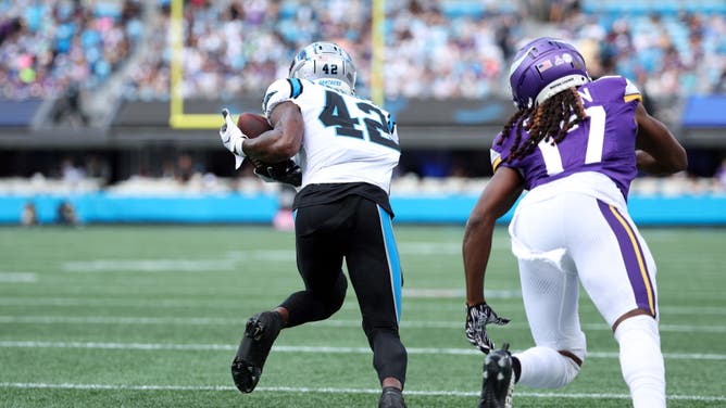 Sam Franklin Jr. of the Carolina Panthers intercepts Kirk Cousins of the Minnesota Vikings and returns it for a 99-yard touchdown during the first quarter at Bank of America Stadium on October 01, 2023 in Charlotte, North Carolina.