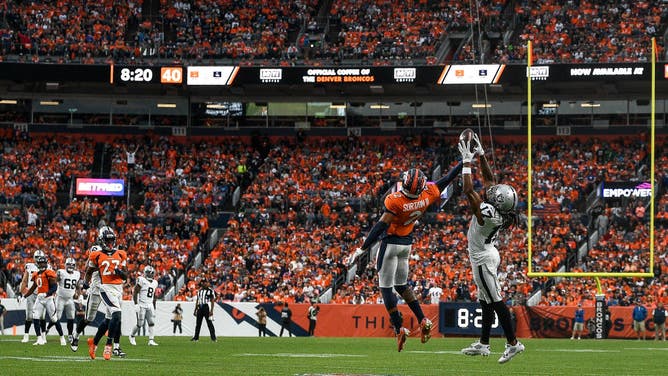 Broncos CB Pat Surtain II breaks up a pass intended for Raiders WR Davante Adams at Empower Field at Mile High.