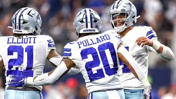Dak Prescott, #4 of the Dallas Cowboys, celebrates with Ezekiel Elliott, #21, and Tony Pollard, #20, after a touchdown against the Detroit Lions during the fourth quarter at AT&T Stadium on Oct. 23, 2022 in Arlington, Texas.