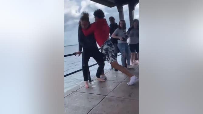 Man Thrown Into The Ocean During A Fight On A Pier