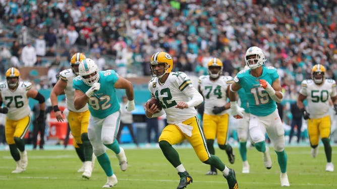 Green Bay Packers QB Aaron Rodgers scrambles during the 2nd half of the game against the Miami Dolphins at Hard Rock Stadium in Miami Gardens, Florida.