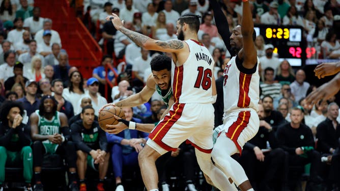 Celtics SF Jayson Tatum is doubled on the baseline by Heat SF Caleb Martin and C Bam Adebayo in the 4th quarter during Game 4 of the Eastern Conference Finals.