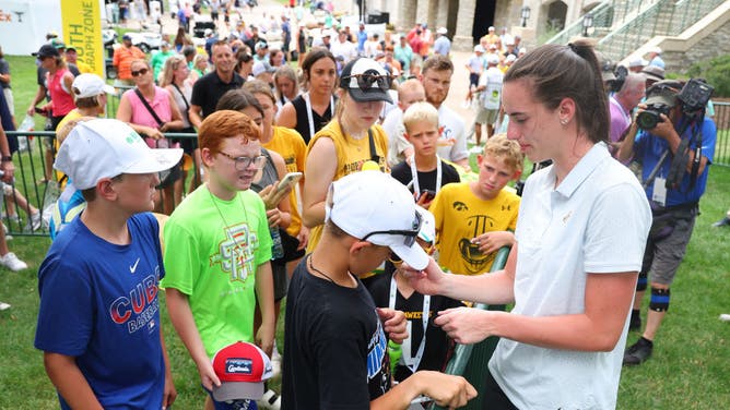Caitlin Clark of the Iowa Hawkeyes signs autographs for fans during the pro-am prior to the John Deere Classic at TPC Deere Run on July 05, 2023 in Silvis, Illinois.