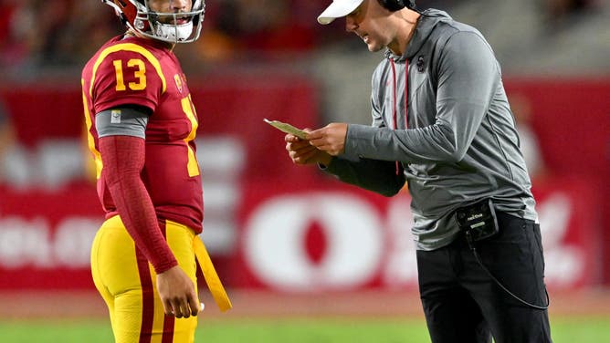 USC QB Caleb Williams talks with coach Riley during the game vs. the Fresno State Bulldogs at United Airlines Field at the Los Angeles Memorial Coliseum.
