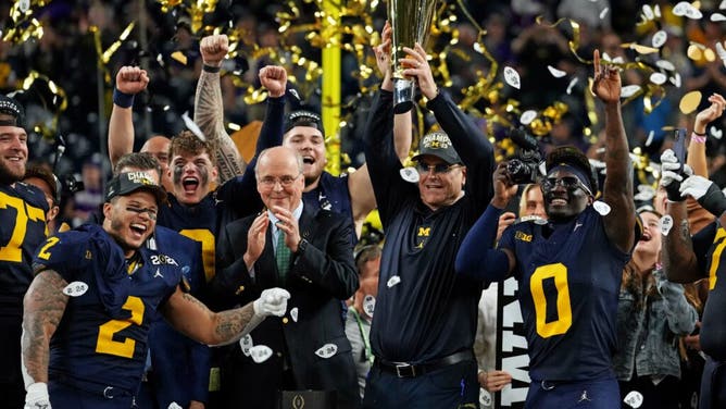 Michigan Wolverines head coach Jim Harbaugh celebrates with the CFP Championship trophy after beating the Washington Huskies in the 2024 title game at NRG Stadium in Houston, Texas.