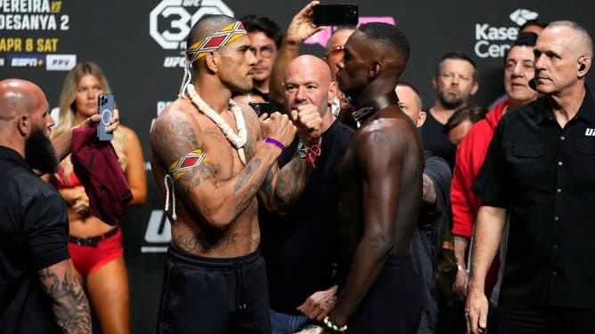 Opponents Alex Pereira and Israel Adesanya face off during the UFC 287 ceremonial weigh-in at Kaseya Center in Miami, Florida.