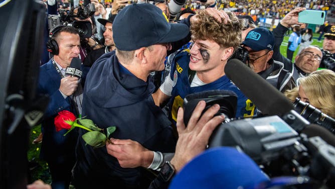 Head coach Jim Harbaugh and quarterback J.J. McCarthy of the Michigan Wolverines celebrate after beating the Alabama Crimson Tide in the CFP Semifinal Rose Bowl Game.