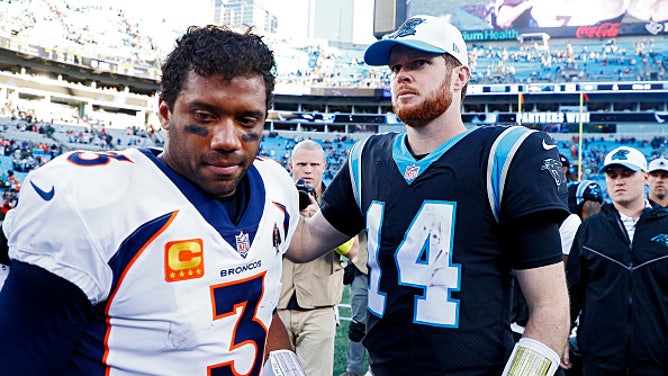Broncos QB Russell Wilson on the field with Panthers QB Sam Darnold