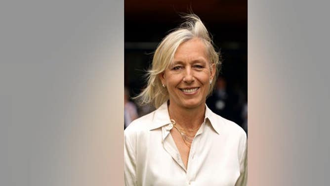 Martina Navratilova smiles after meeting Britain's Queen Elizabeth at the Queen attends the Wimbledon Lawn Tennis Championships at the All England Lawn Tennis and Croquet Club in London June 24, 2010.REUTERS/Pool/Oli Scarf (BRITAIN - Tags: SPORT TENNIS ROYALS ENTERTAINMENT) - RTR2FN8W