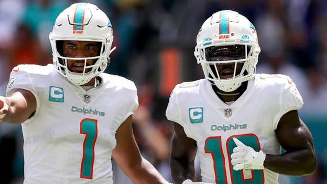 Tua Tagovailoa, #1, and Tyreek Hill, #10 of the Miami Dolphins, in action during the first half of the game against the Buffalo Bills at Hard Rock Stadium on Sept. 25, 2022 in Miami Gardens, Florida.