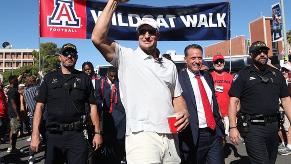 Honorary team captain and Arizona Wildcat alumni Rob Gronkowski and Arizona Wildcats head coach Jedd Fisch arrive for a football game between the USC Trojans and the University of Arizona Wildcats on Oct. 29, 2022 at Arizona Stadium in Tucson, Arizona.