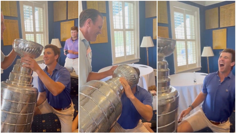 ELi Manning chugs beer out of Stanley Cup.