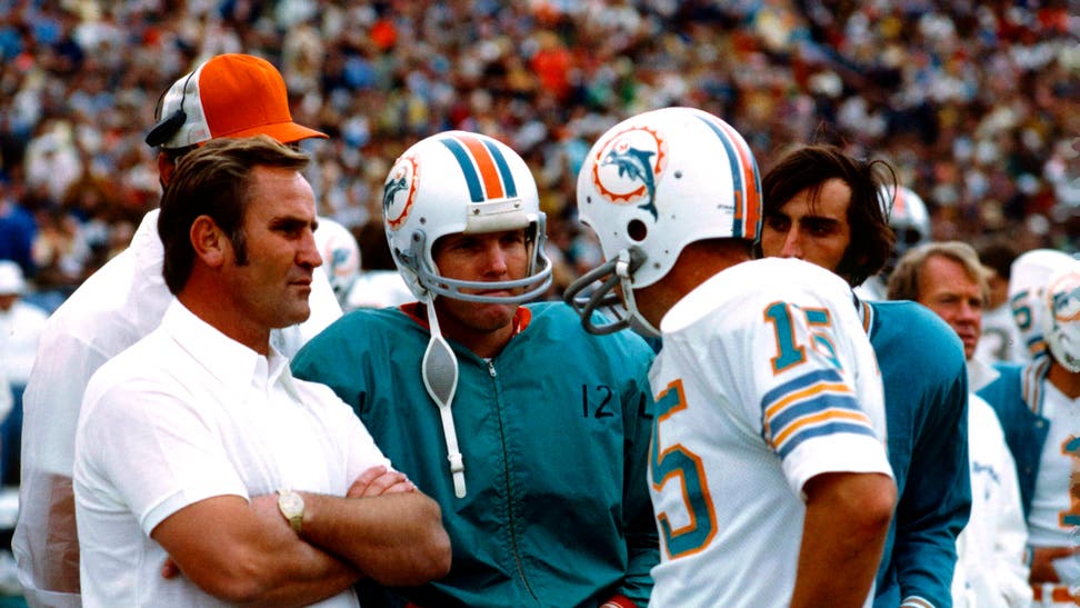 Don Shula, Miami Dolphins Coach, speaks with Quarterback Bob Griese and Quarterback  Earl Morrall during an NFL football game against the Baltimore Colts in Miami, Florida, December 16, 1972.