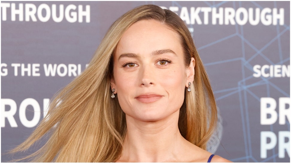 Brie Larson needed to check her height, and went viral in the process. She shared a viral Instagram photo of herself in a red dress. (Credit: Getty Images)