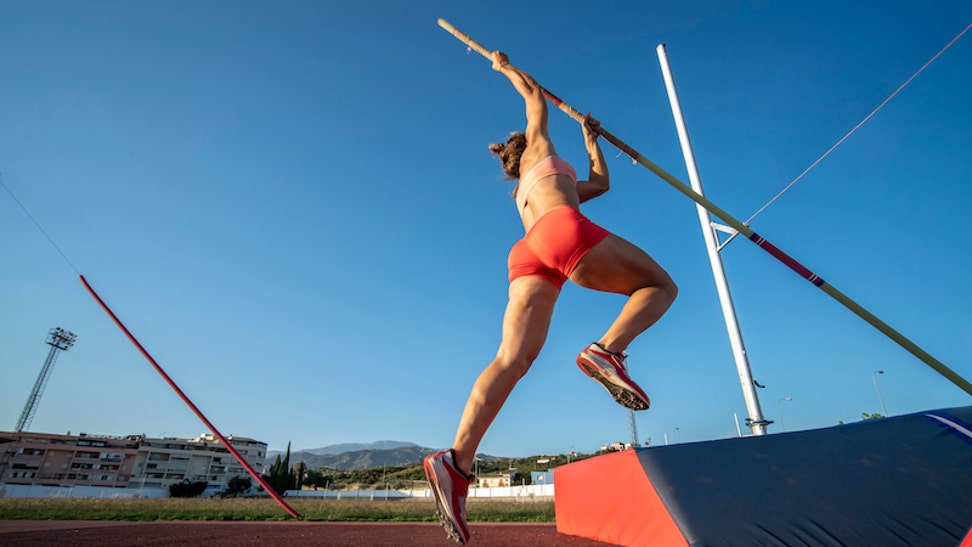a30347be-Young Woman Pole-Vaulting