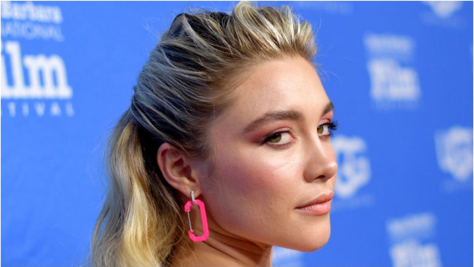 Florence Pugh had a rough time with a fan during a film event in Brazil. She got smoked in the face by an object. Watch the video. (Credit: Getty Images)