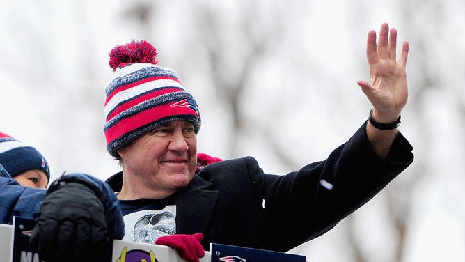 Head coach Bill Belichick of the New England Patriots waves to fans during a Super Bowl victory parade on February 4, 2015 in Boston, Massachusetts.