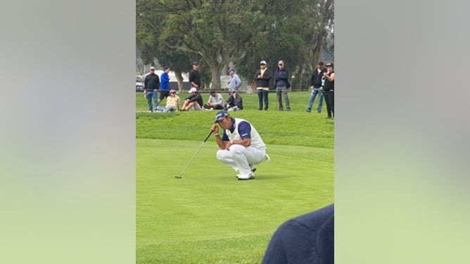 Hideki Matsuyama lining up a putt on the 11th green at the Riviera Country Club in the 2024 Genesis Invitational. 