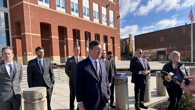 State of Tennessee attorneys meet outside the courthouse following the induction hearing against NCAA