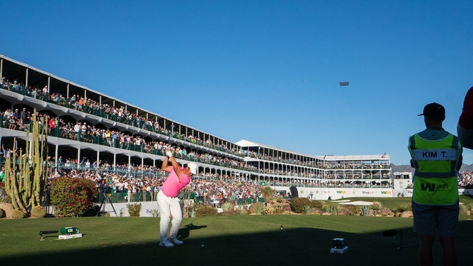 Tom Kim hits his tee shot on the 16th hole during the 3rd round of the 2023 WM Phoenix Open.