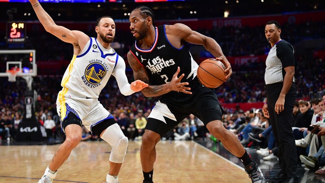 Los Angeles Clippers All-Star Kawhi Leonard gathers for a step-back three with Golden State Warriors' Stephen Curry defending at Crypto.com Arena. (Gary A. Vasquez-USA TODAY Sports)