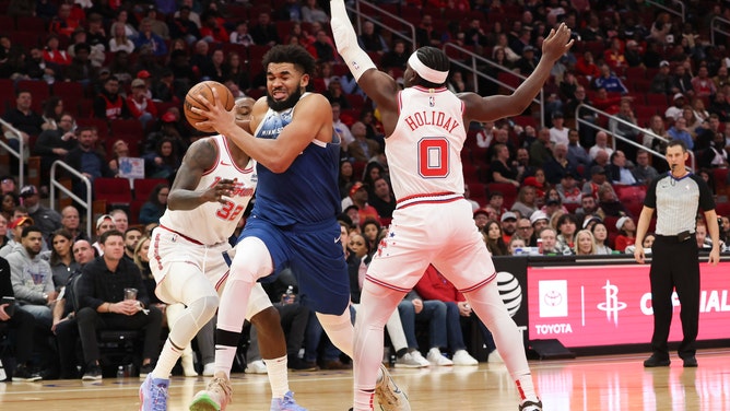 Minnesota Timberwolves C Karl-Anthony Towns drives past Houston Rockets PF Jeff Green and SG Aaron Holiday at Toyota Center in Texas.