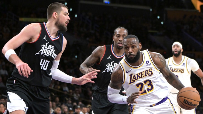Los Angeles Lakers' LeBron James attacks Clippers C Ivica Zubac and All-Star Kawhi Leonard at Crypto.com Arena. 
