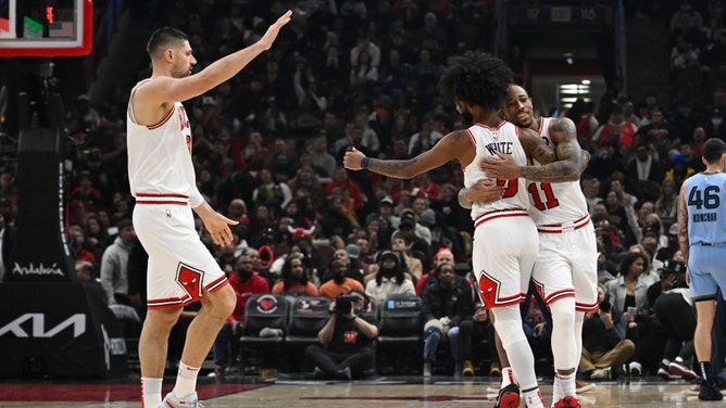 Chicago Bulls SF DeMar DeRozan celebrates with PG Coby White and C Nikola Vucevic vs. the Memphis Grizzlies at the United Center in Illinois.