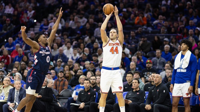New York Knicks SF Bojan Bogdanovic shoots a three over Philadelphia 76ers PG Tyrese Maxey at Wells Fargo Center.