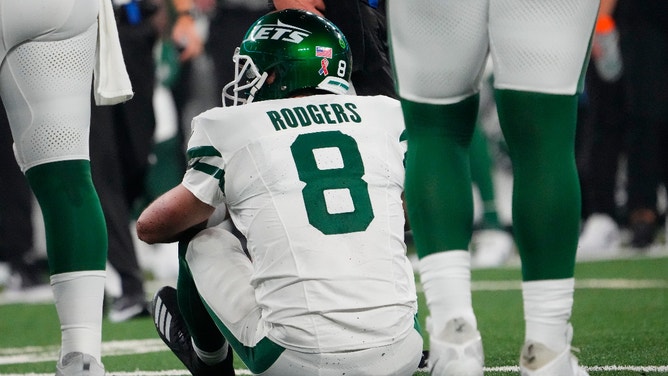 New York Jets quarterback Aaron Rodgers (8) sits on the field after a sack by Buffalo Bills defensive end Leonard Floyd (not pictured) at MetLife Stadium. Rodgers left the game with an injury after the play.