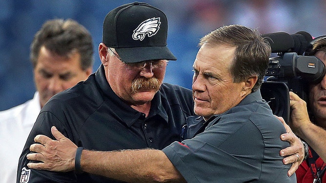 Patriots head coach Bill Belichick embraces Eagles head coach Andy Reid