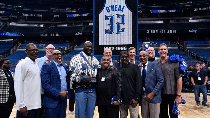 Shaquille O'Neal poses for pictures during his jersey retirement for the Orlando Magic.