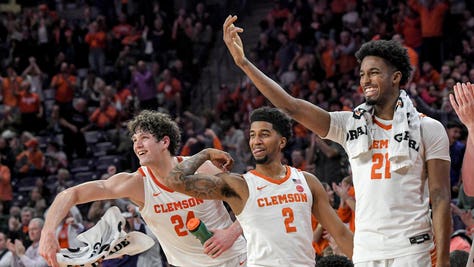 Clemson PF P.J. Hall (24), left, SG Dillon Hunter, and SF Chauncey Wiggins celebrate after Clemson senior 3-pointer against the Miami Hurricanes at Littlejohn Coliseum. (Ken Ruinard-USA TODAY Sports)