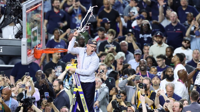 UConn head coach Dan Hurley cuts down the net after defeating the San Diego State Aztecs in the national championship of the 2023 NCAA Tournament at NRG Stadium in Houston. (Troy Taormina-USA TODAY Sports)