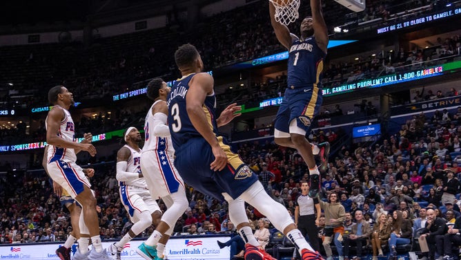 New Orleans Pelicans SG C.J. McCollum throws an alley-oop pass to PF Zion Williamson vs. the Philadelphia 76ers at the Smoothie King Center. (Stephen Lew-USA TODAY Sports)