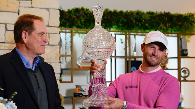 Jim Nance and Wyndham Clark with the AT&T Pro-Am trophy at at Pebble Beach Golf Links in California. (Michael Madrid-USA TODAY Sports)