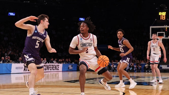 Connecticut Huskies PG Tristen Newton dribbles the ball past Northwestern Wildcats SG Ryan Langborg in the 2024 NCAA Tournament at the Barclays Center in Brooklyn. (Brad Penner-USA TODAY Sports)