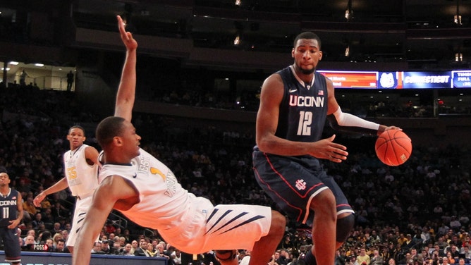 Former UConn Huskies C Andre Drummond runs over former West Virginia Mountaineers PF Dominique Rutledge during the 2012 Big East Tournament at Madison Square Garden. (Anthony Gruppuso-USA TODAY Sports)