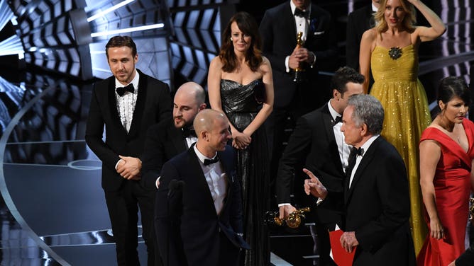 Warren Beatty approaches 'La La Land' producers on stage as they celebrate after the film was mistakenly named Best Picture during the 89th Academy Awards at Dolby Theatre in Los Angeles. (Robert Deutsch-USA TODAY NETWORK)