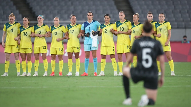 Sam Kerr (#2) and her Australian teammates link arms prior to an Olympics match against New Zealand. They claim that the gesture was for 