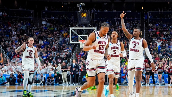 The South Carolina Gamecocks celebrate after guard Ta'Lon Cooper made a last-second shot before half-time against the Oregon Ducks in the first round of the 2024 NCAA Tournament.