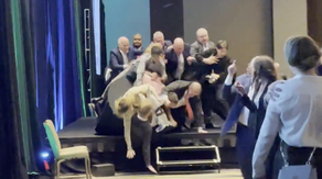 Climate activists fall off stage