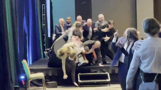 Climate activists fall off stage