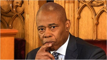 New York Mayor Eric Adams was screamed at while on a plane for his stance on Israel and NYC having homeless people. Watch the video. (Credit: Getty Images)