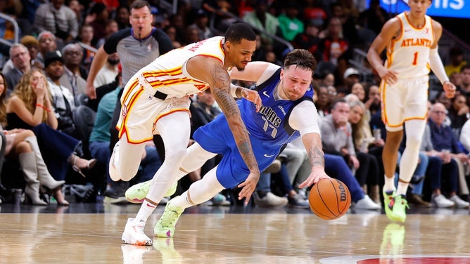 Dallas Mavericks All-Star Luka Doncic battles for a loose ball with Atlanta Hawks PG Dejounte Murray at State Farm Arena in Georgia. (Todd Kirkland/Getty Images)
