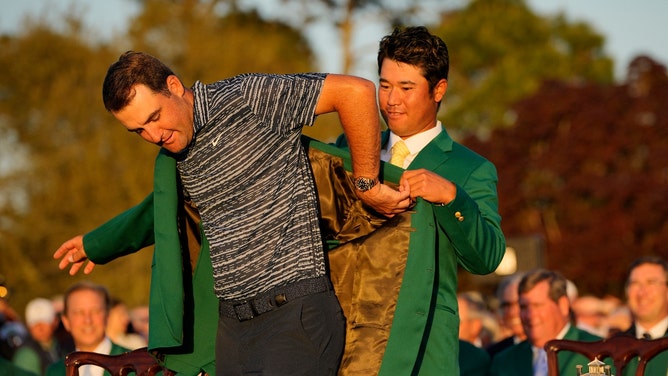 The 2021 Masters Champion, Hideki Matsuyama, puts the green jacket on 2022 Masters champion, Scottie Scheffler at Augusta National Golf Club. (Adam Cairns-Augusta Chronicle/USA TODAY Sports)