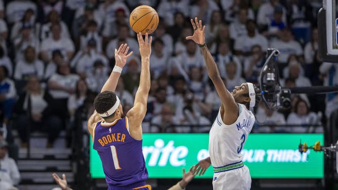Phoenix Suns SG Devin Booker shoots a contested jumper over Timberwolves SF Jaden McDaniels during Game 1 of the 1st round for the 2024 NBA playoffs at Target Center in Minnesota. (Jesse Johnson-USA TODAY Sports)