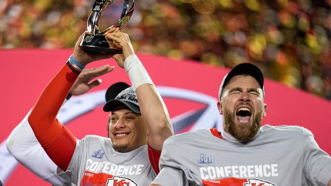 Patrick Mahomes raises the Lamar Hunt Trophy while Travis Kelce celebrates after the Kansas City Chiefs' 23-20 win over the Cincinnati Bengals in the AFC championship game at Arrowhead Stadium.