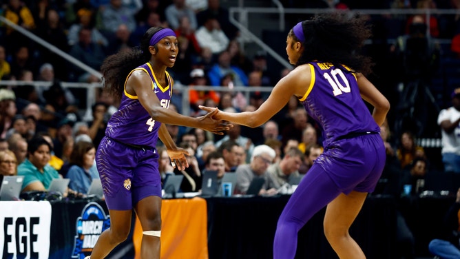 LSU Lady Tigers guard Flau'jae Johnson and forward Angel Reese react in the first quarter against the Iowa Hawkeyes in the finals of the Albany Regional in the 2024 NCAA Tournament at MVP Arena.