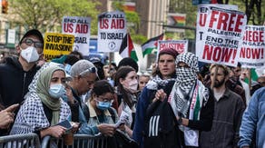 Several hundred anti-Israel protestors stand outside the gates of Columbia University with signs promoting Palestine and Hamas.